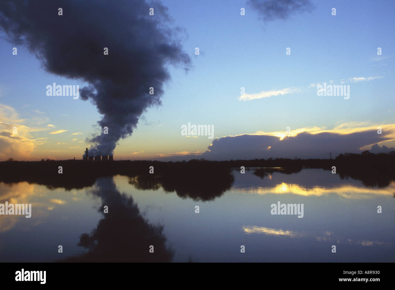 Emission cloud from coal fired Power Station reflected in lake Stock Photo
