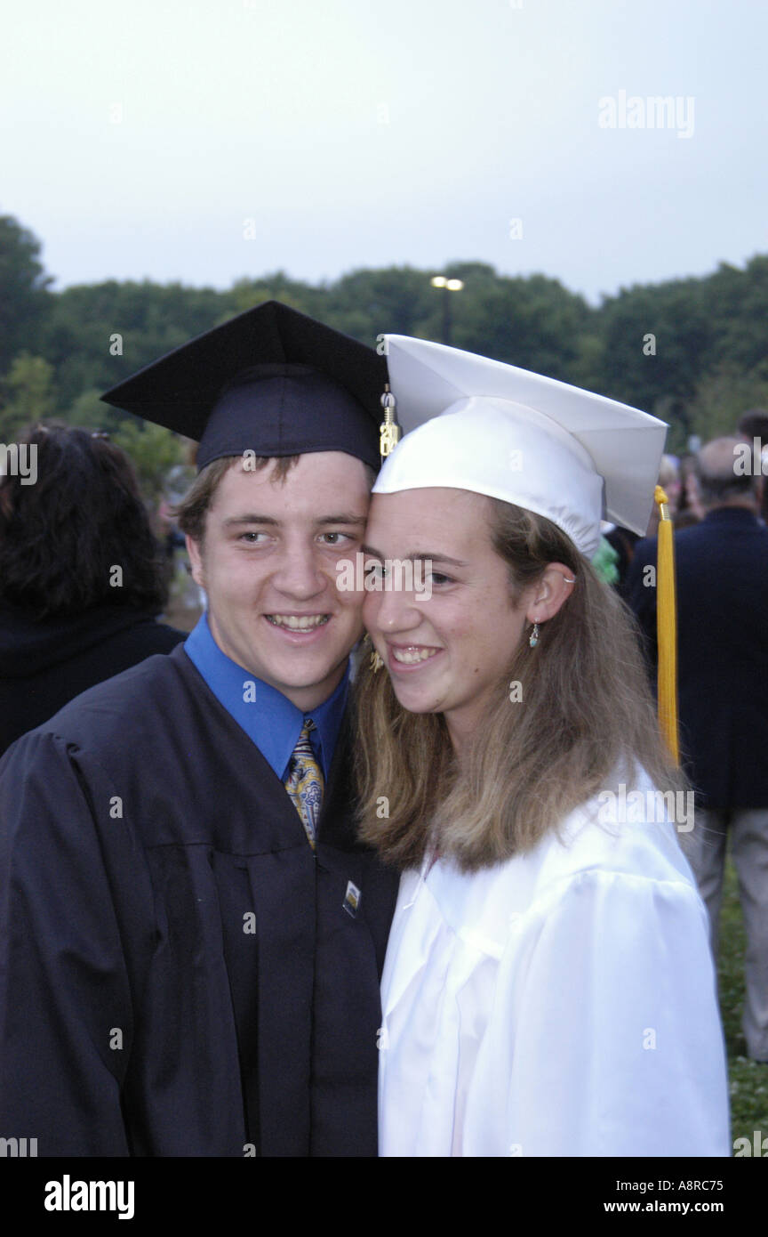 Male and female highschool graduates at graduation ceremonies Stock Photo