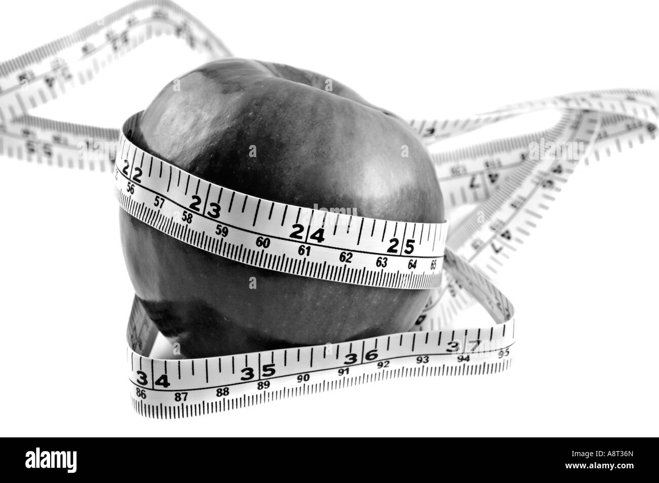 Pink Lady Apple Wrapped With Tape Measure B W Stock Photo