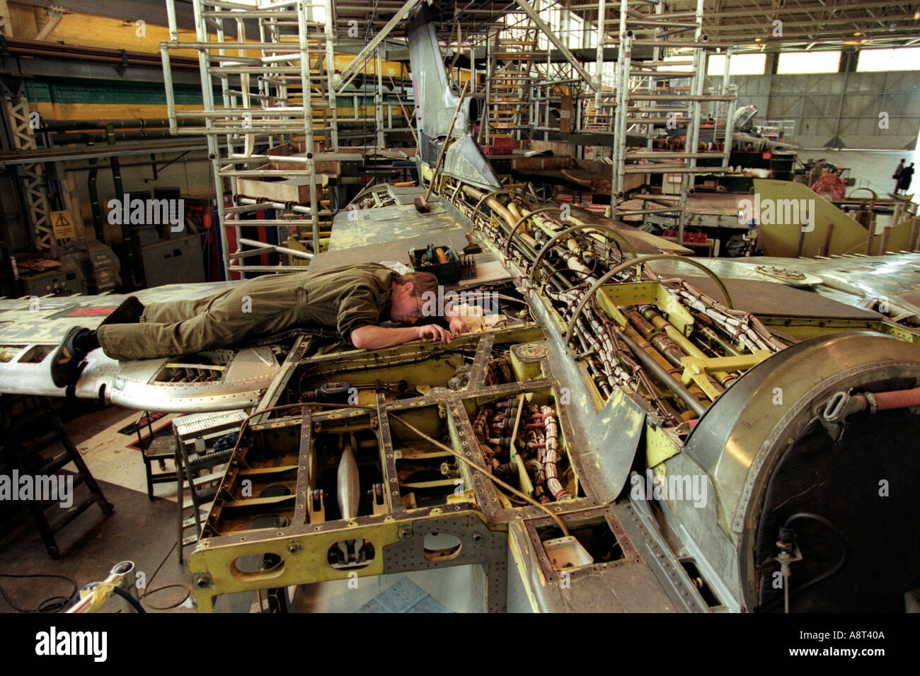 Technicians work on a Tornado GR4 fighter jet at RAF St Athan South