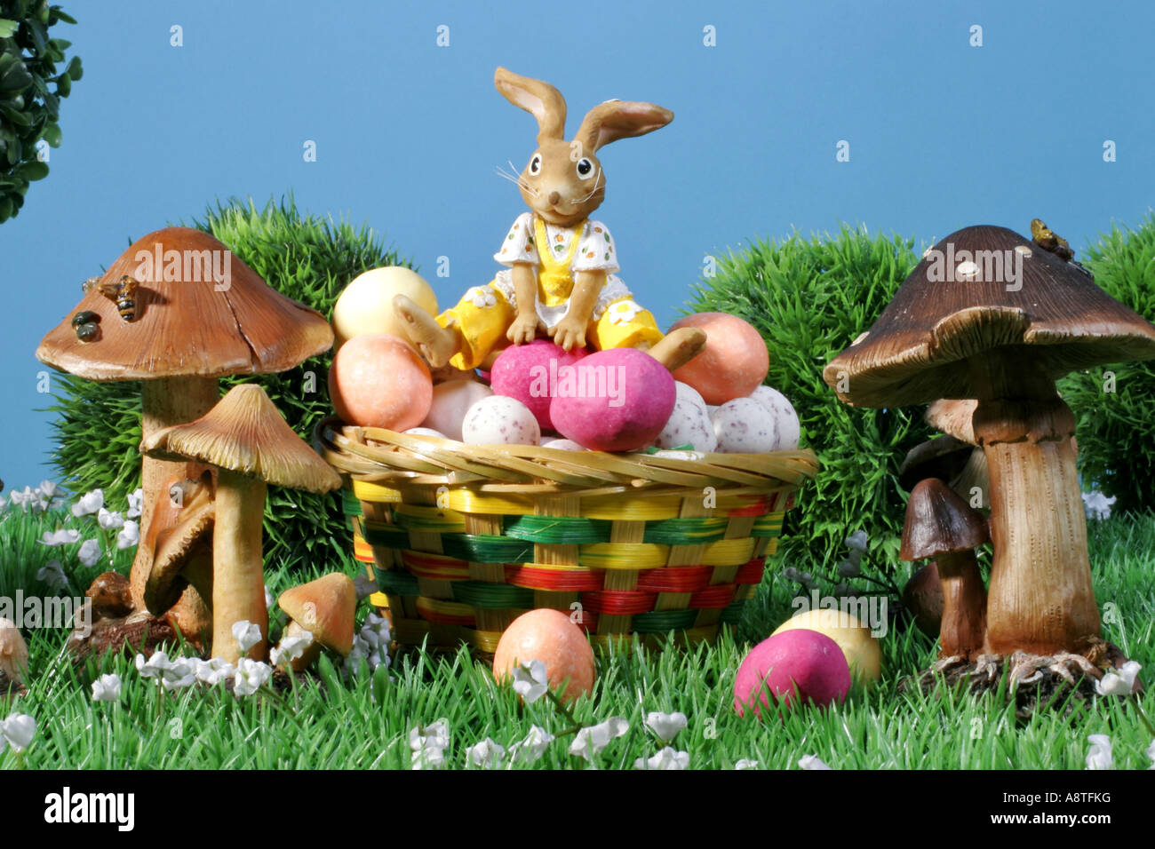 easter bunny sitting on a basket full with Easter eggs Stock Photo - Alamy