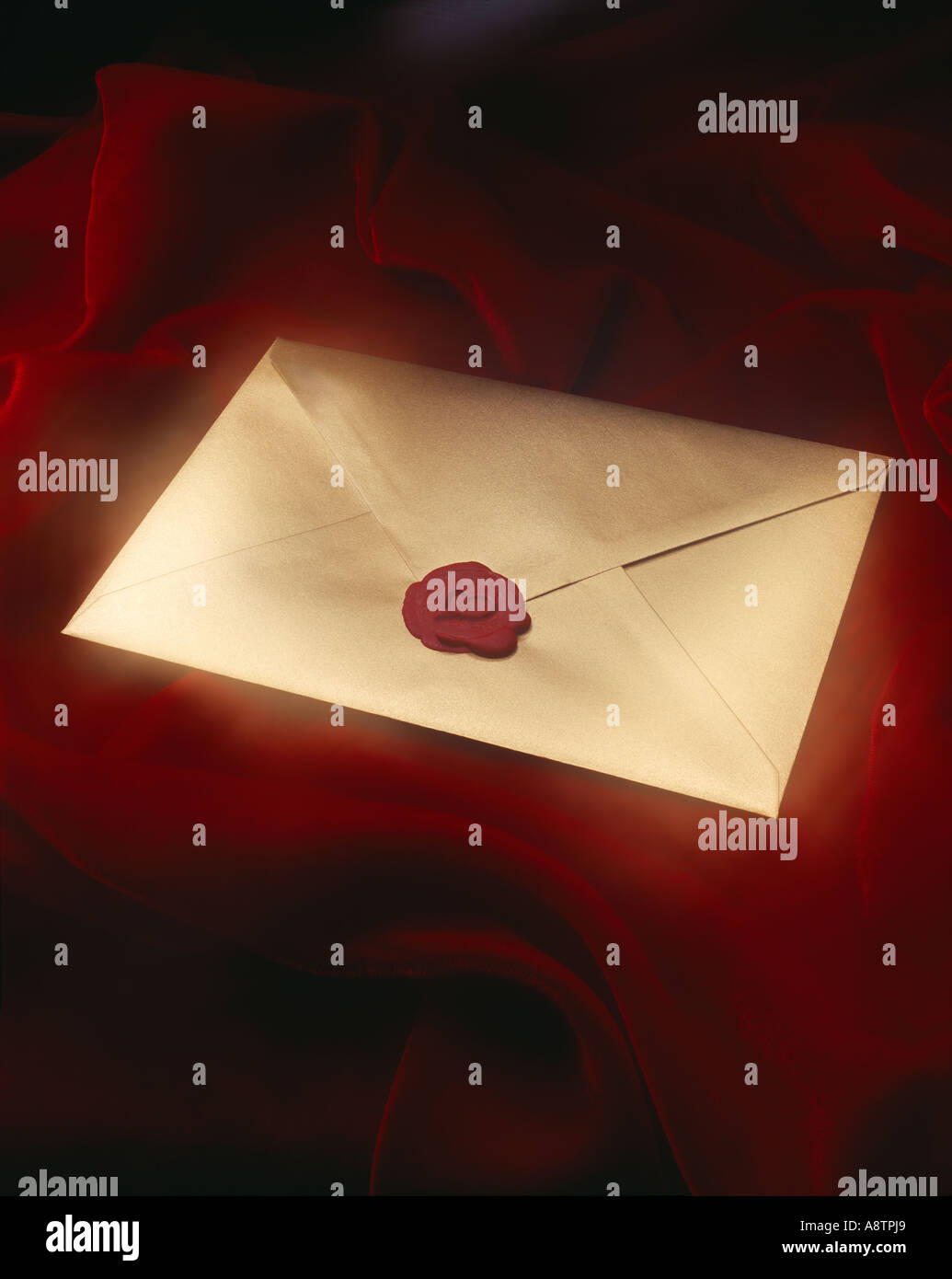 gold ,envelope, with heart embossed seal on red velvet Stock Photo Alamy