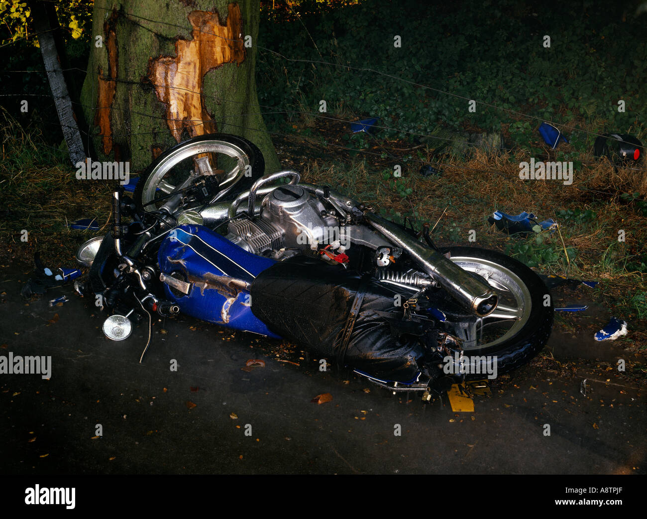 Motorcycle abandoned having been smashed into a tree Stock Photo - Alamy