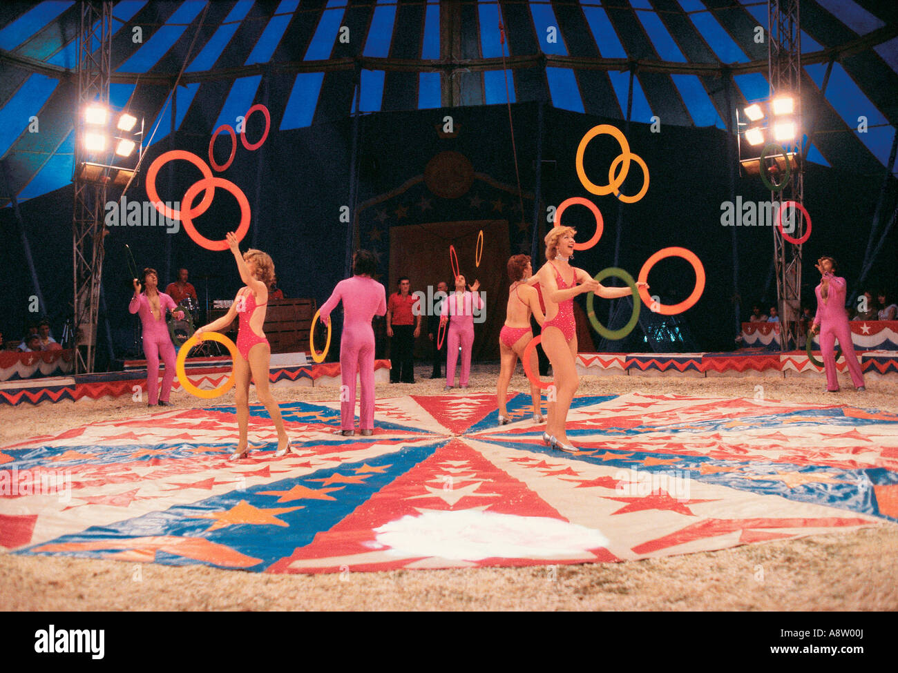 Inside big top tent Circus performers juggling act. Stock Photo