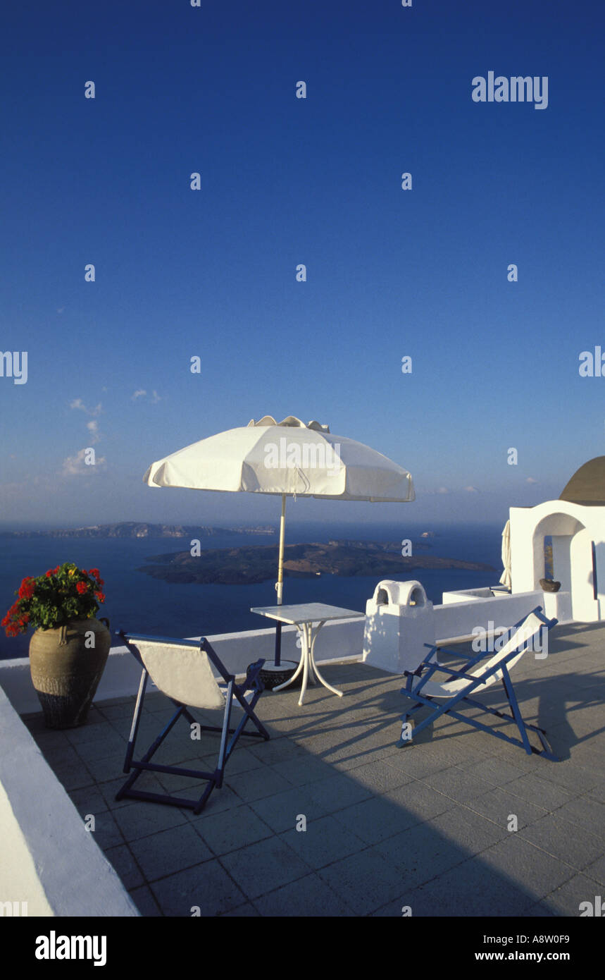 Two deck chairs sunshade terrace at the sea Santorini Island Greece Stock Photo