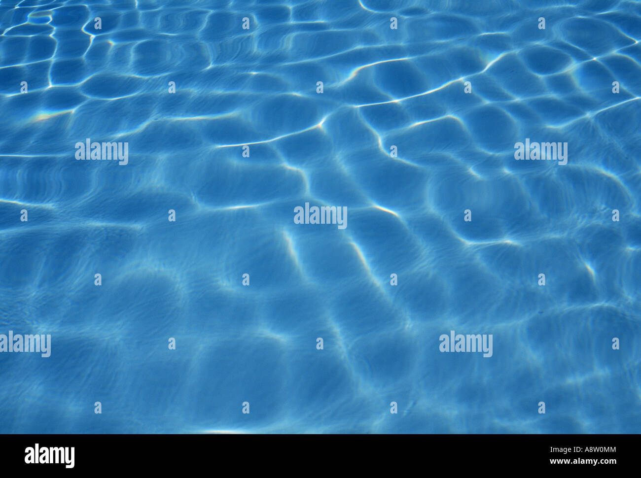 View of sunlight patterns on swimming pool blue water surface Stock ...