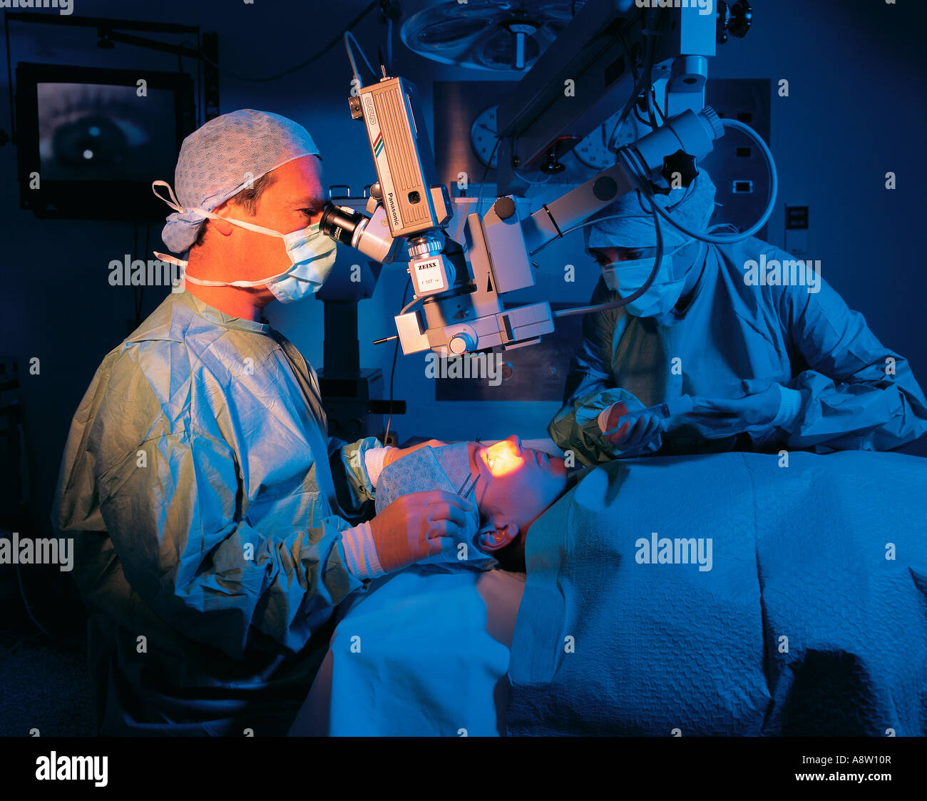 Surgeon undertaking eye surgery detached retina operation Stock Photo