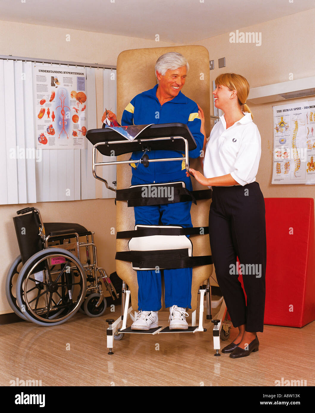 Hospital. Young woman Physiotherapist conducting neuro rehabilitation with male patient Stock Photo