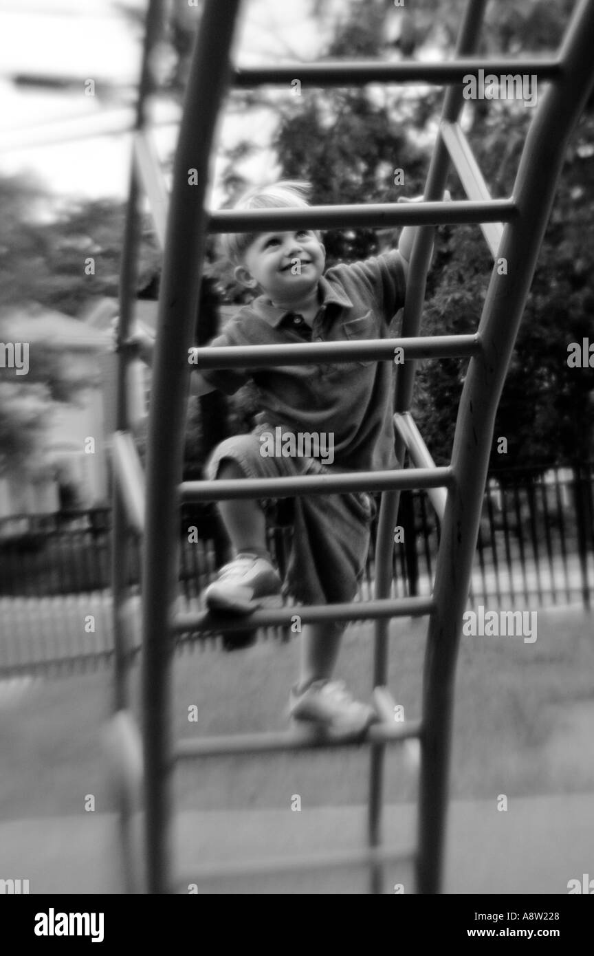 Small Child climbing ladder at playground Stock Photo