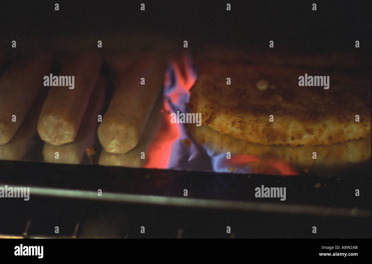 Sausages and burger under the grill Stock Photo Alamy