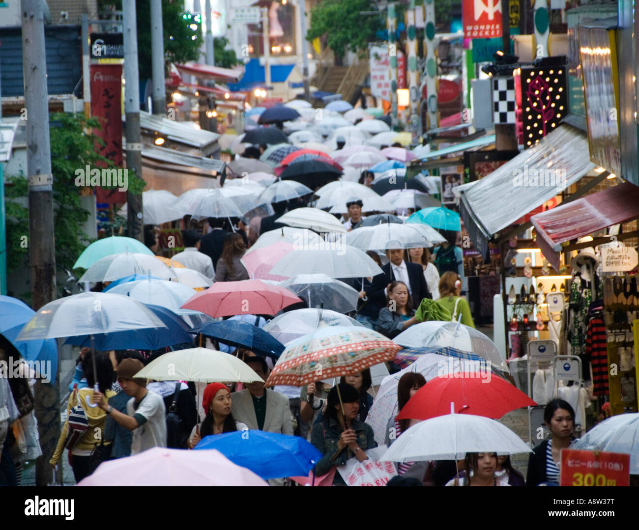 Rain falling on umbrellas in busy Takeshita Street in Harajuku Tokyo Japan Stock Photo