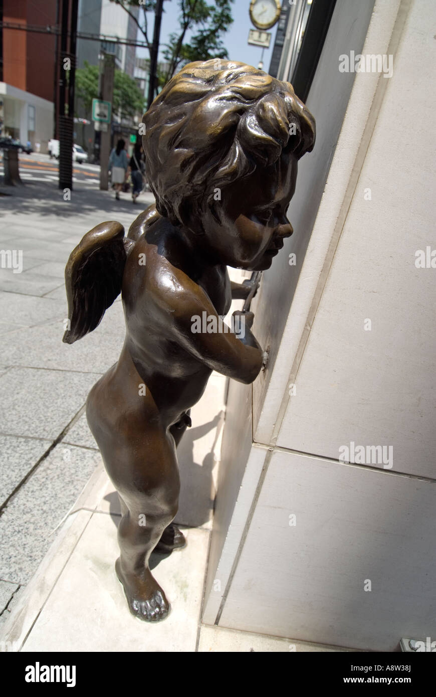 Statue of cupid on street corner outside jewelery shop in Ginza Tokyo Japan Stock Photo