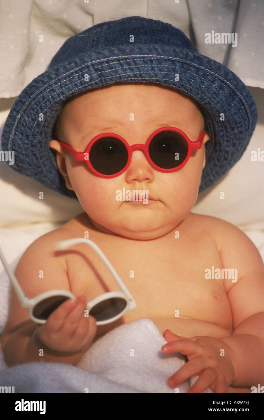 Baby looking cute in cool sunglasses and hat Stock Photo - Alamy