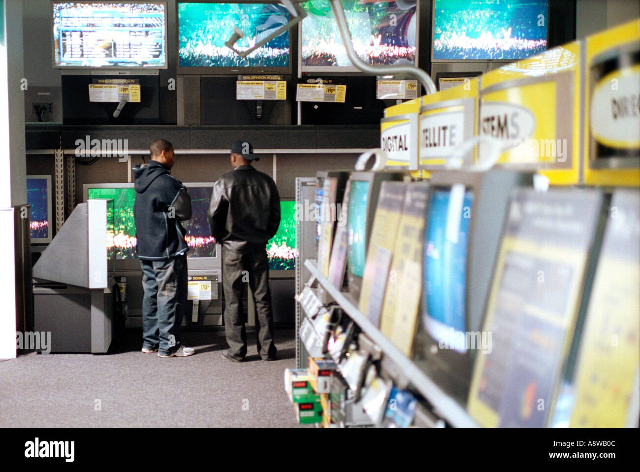 Customers at Best Buy electronics store browse the large flat screen