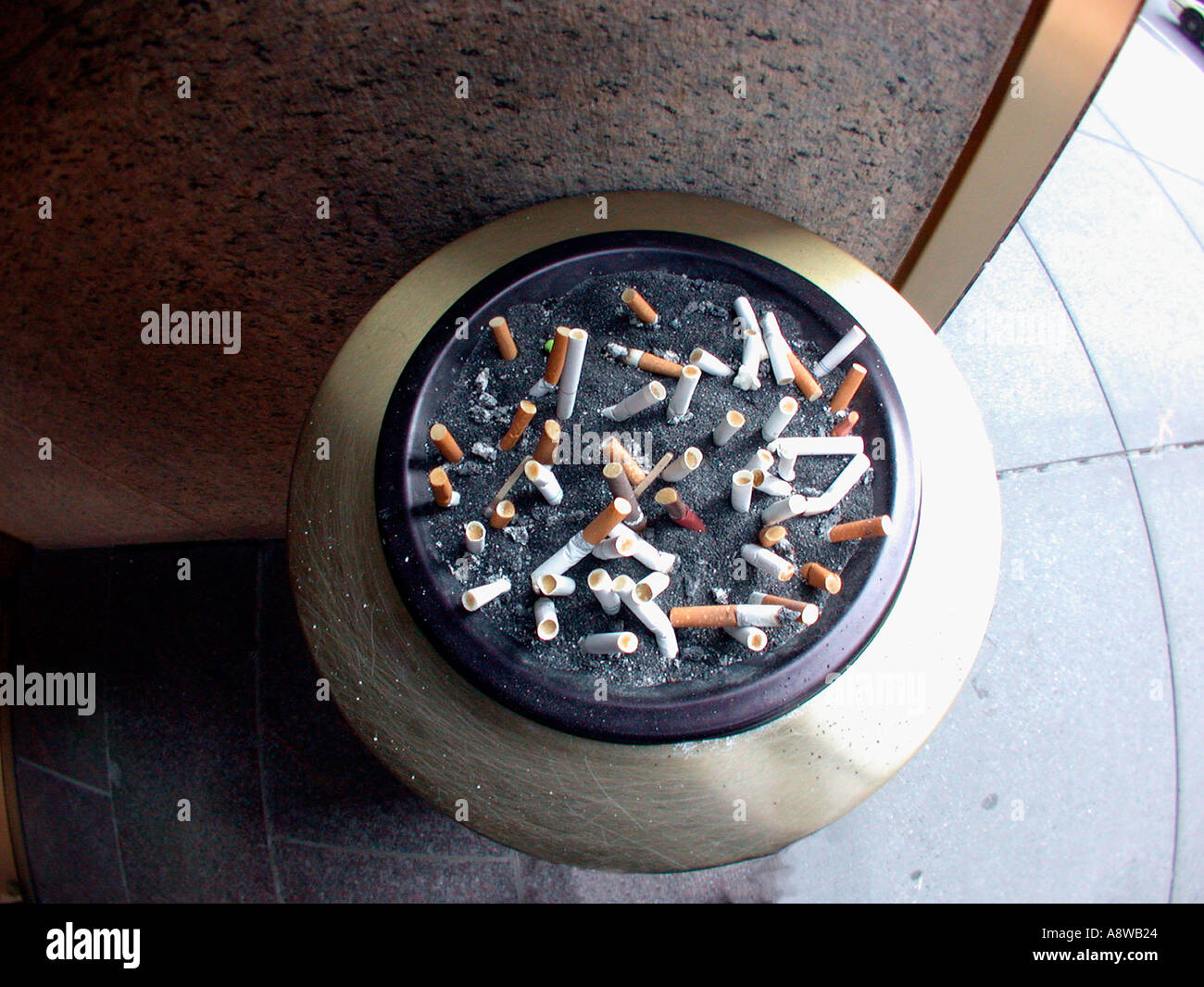 Cigarette butts left by workers on smoking break litter an ashtray