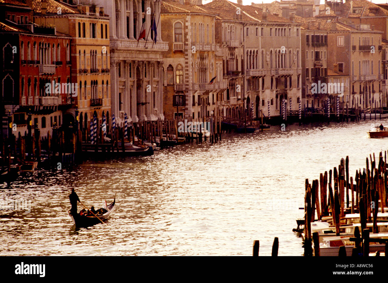 Gondoala on Grand Canal with typical Venusian canal building late afternoon on a sunny day Venice Italy Europe Stock Photo