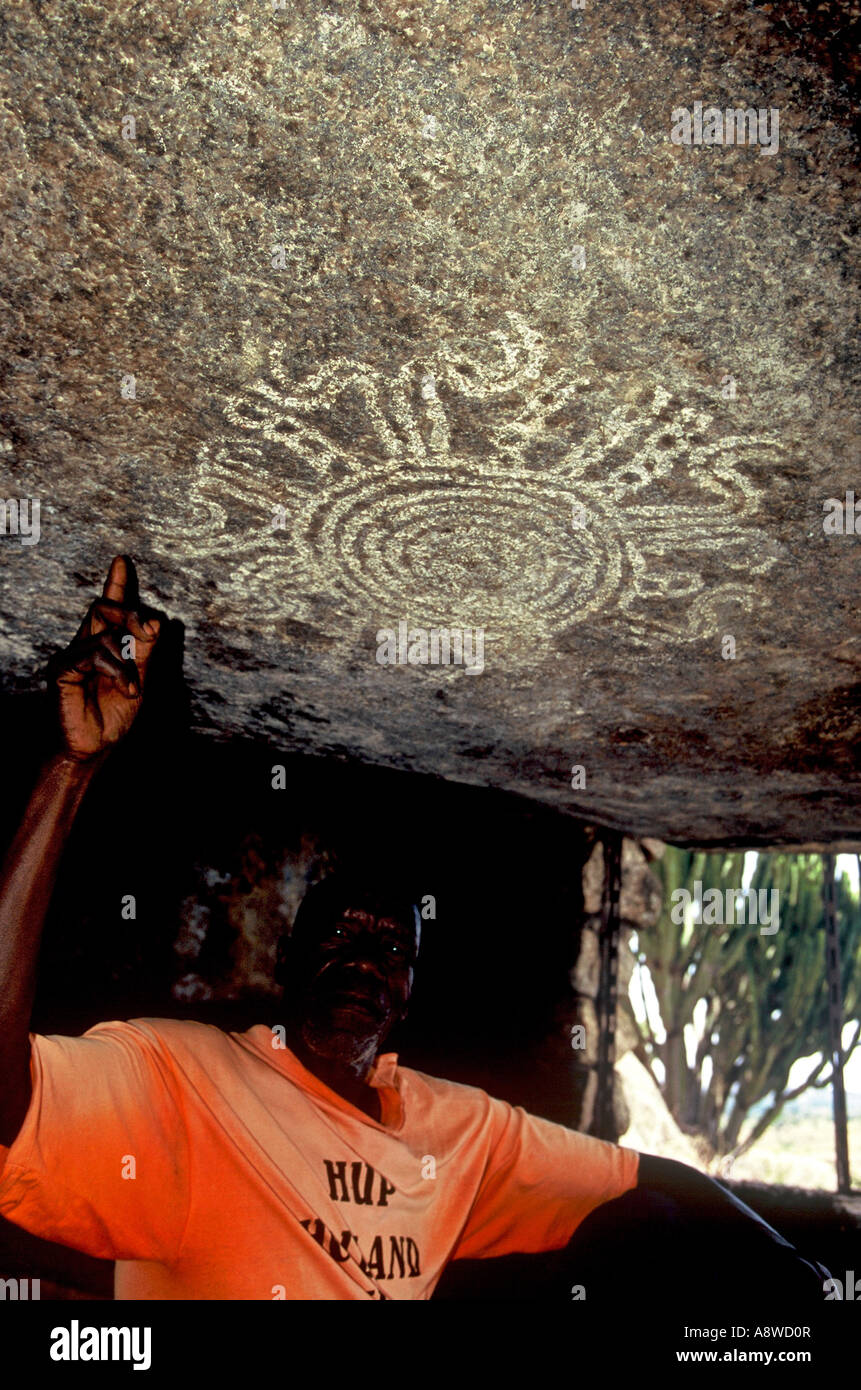 Site Custodian in cave, Uganda Stock Photo