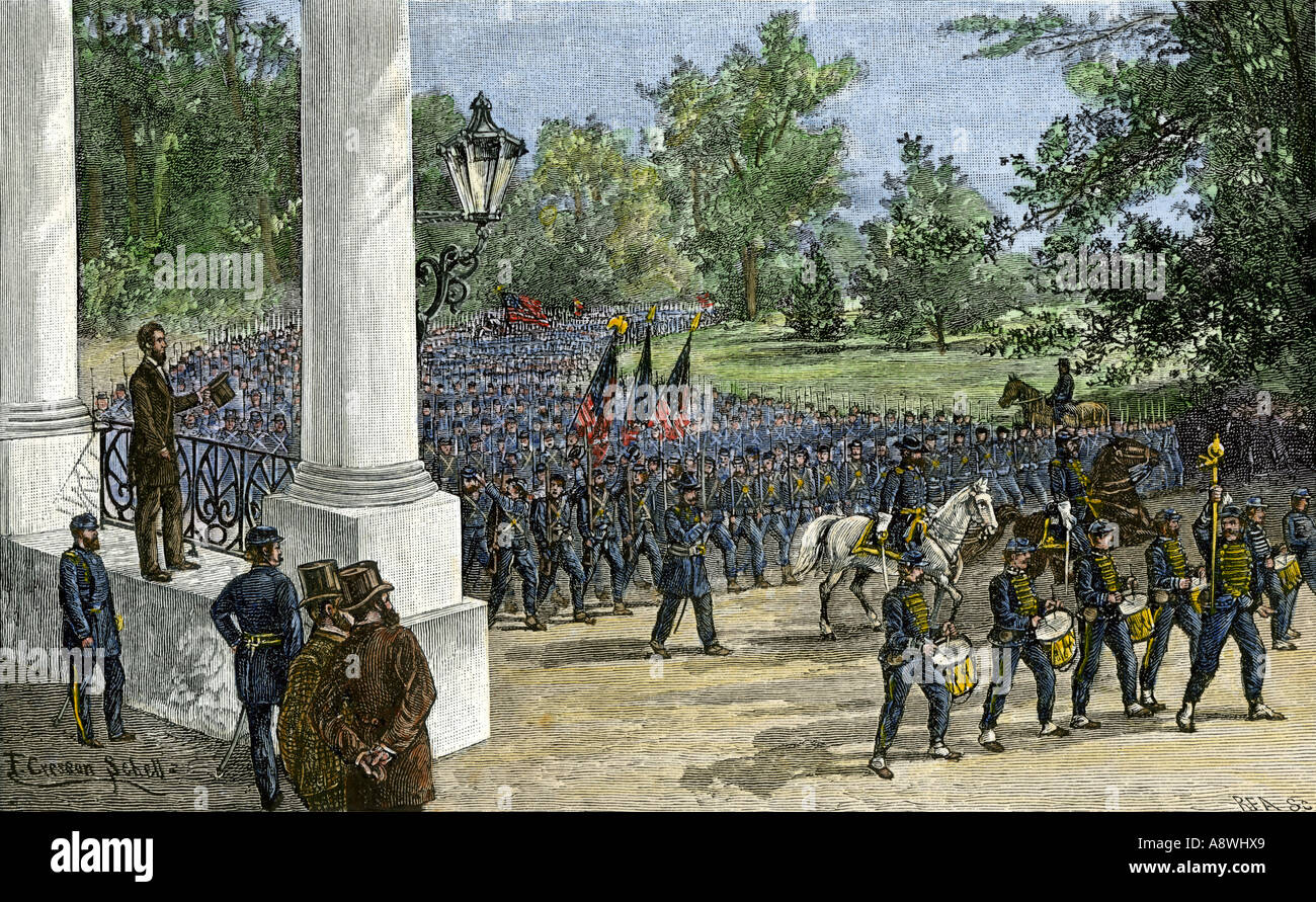 Union troops reviewed by President Abraham Lincoln as they march past the White House to join the Civil War 1860s. Hand-colored woodcut Stock Photo