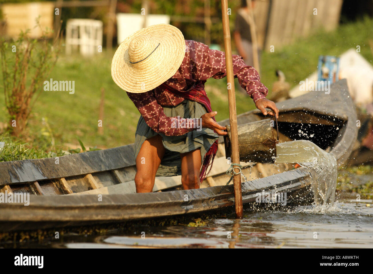 Asia, Myanmar, Inle Lake, Intha man bailing boat Stock Photo