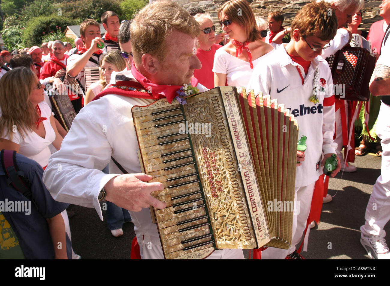 Accordion player with Red Oss May Day Padstow Cornwall UK Stock Photo