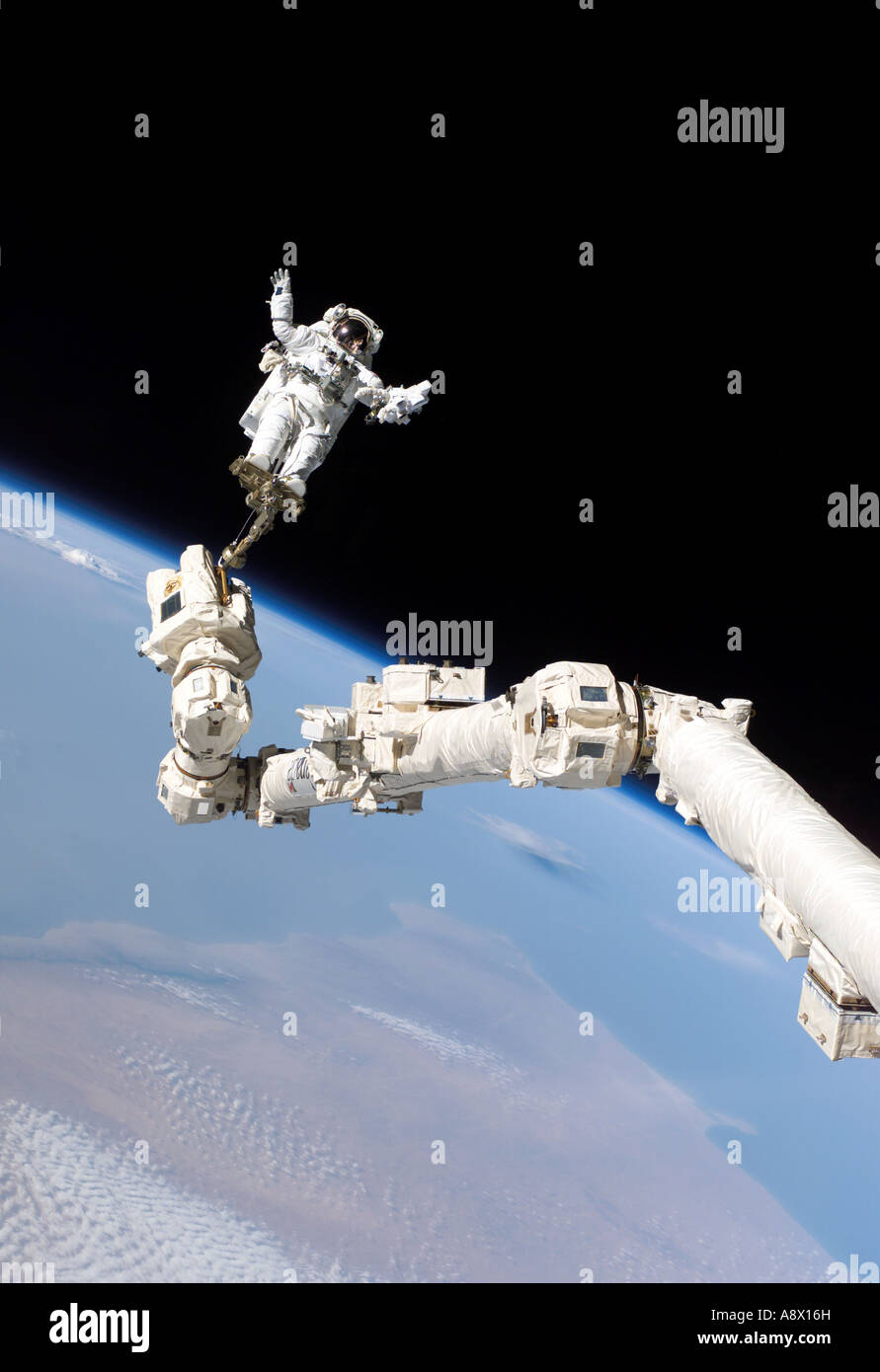 Astronaut Stephen K Robinson anchored to a foot restraint on the International Space Stations Canadarm2 Stock Photo