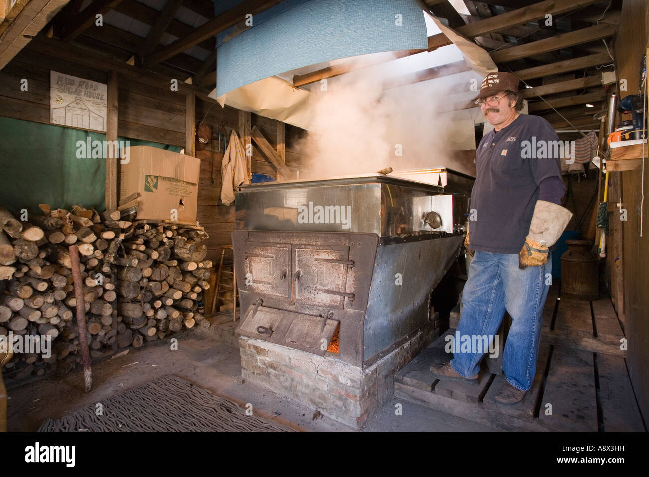 Boiling tree sap in evaporator making maple syrup upstate New York