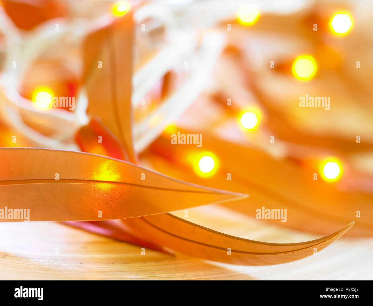 gold coloured fairy light leaves in bowl Stock Photo