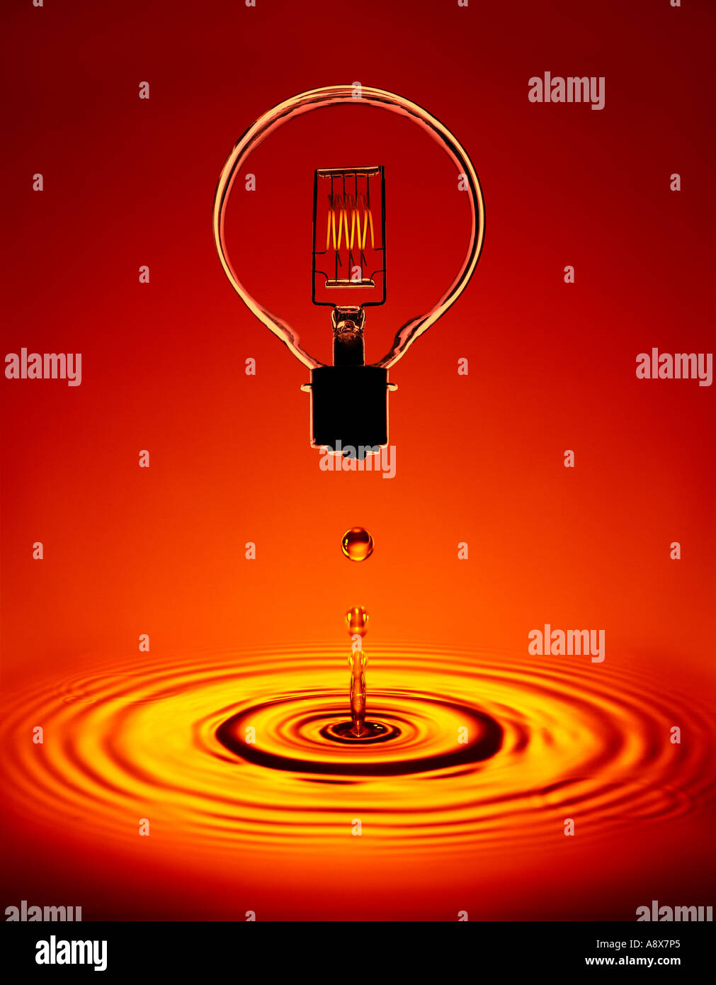 GLASS ELECTRIC LIGHT BULB WITH GLOWING FILAMENT FLOATING ABOVE POOL OF