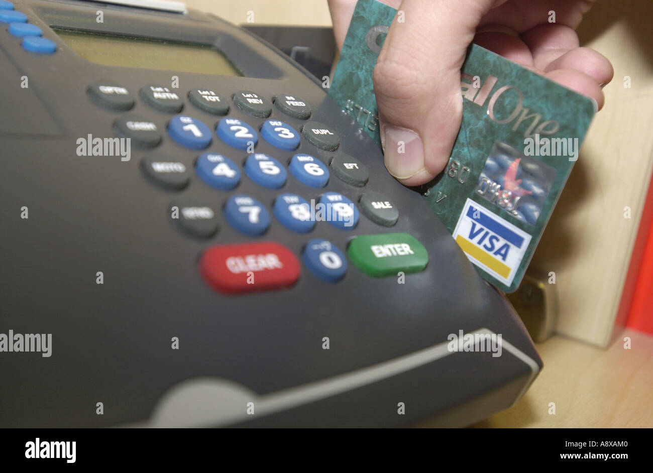 Credit card being swiped through a machine by a man UK Stock Photo Alamy