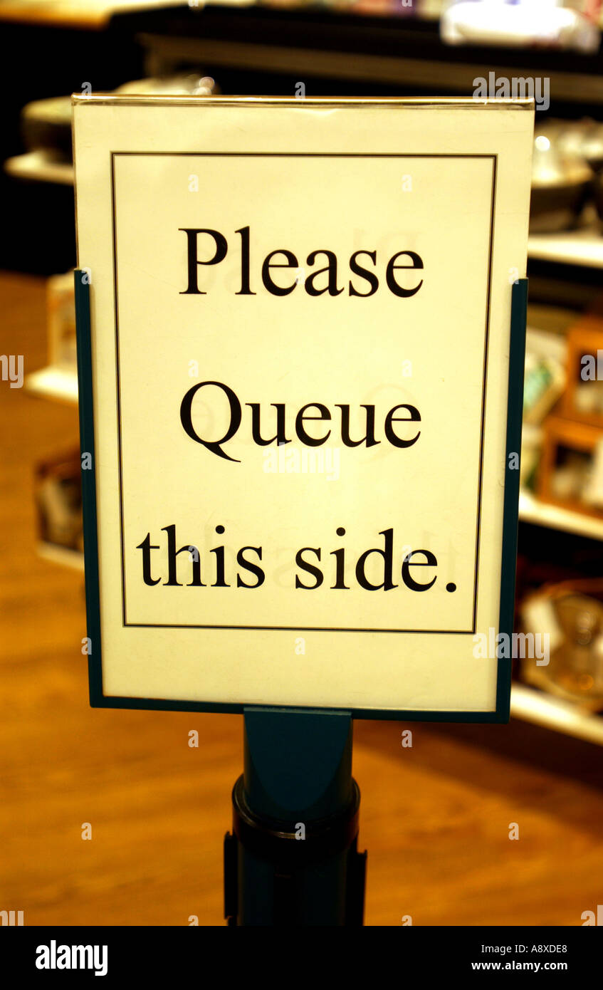 Please queue this side sign Stock Photo