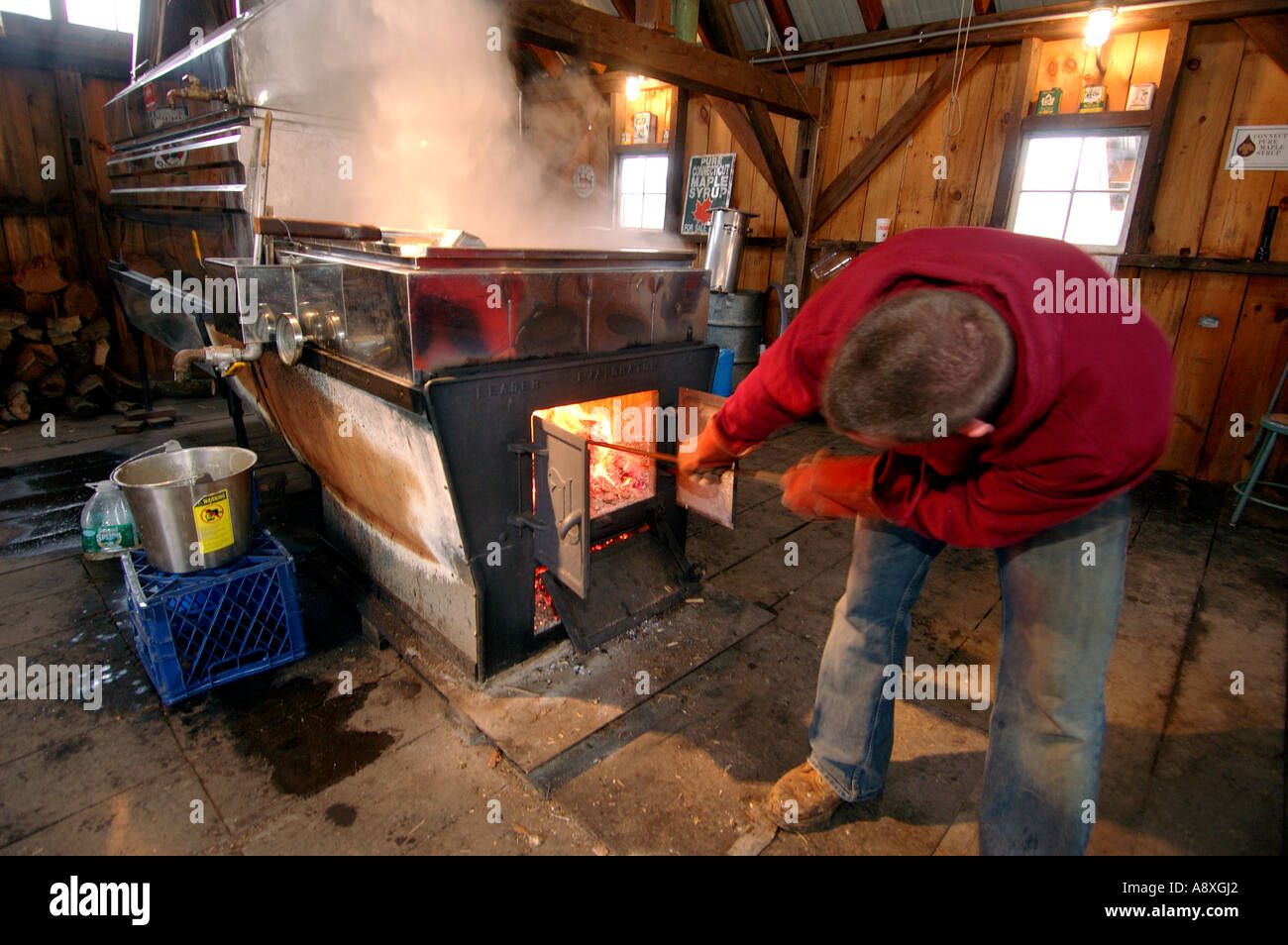 A farmer works the Maple Syrup evaporator Stock Photo Alamy