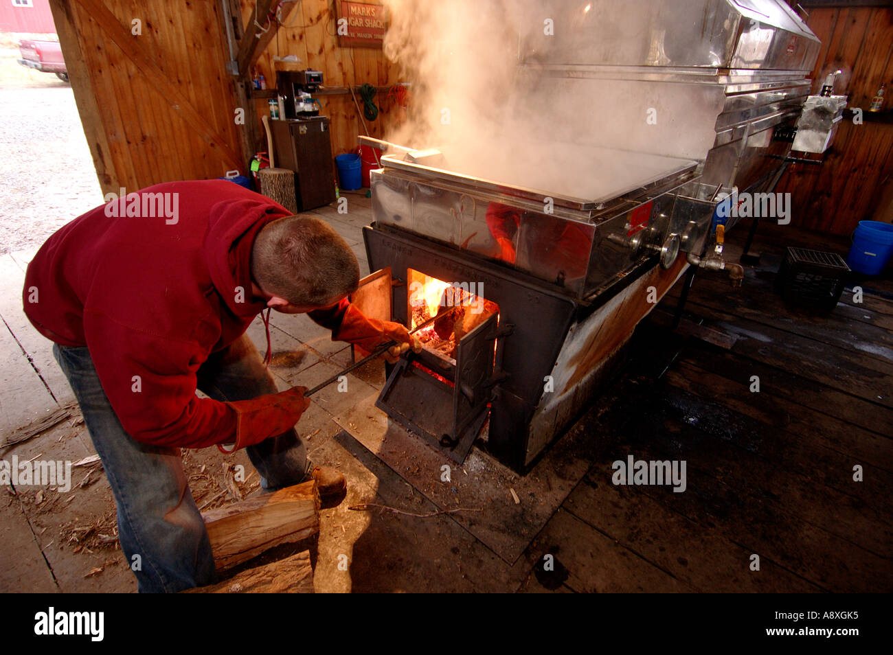 A farmer works the Maple Syrup evaporator Stock Photo Alamy