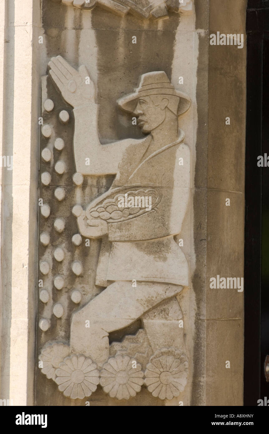 Carving of man scattering seeds by hand (broadcasting) on the entrance to the Cledwyn Building Agricultural economics department Stock Photo