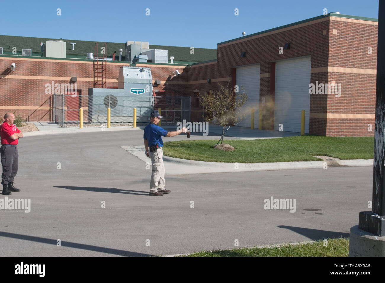 Instructor demonstrates pepper spray for a group of law enforcement and