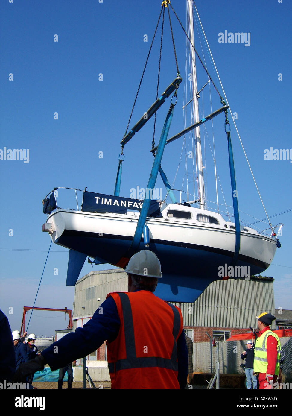 yacht being moved by crane Stock Photo