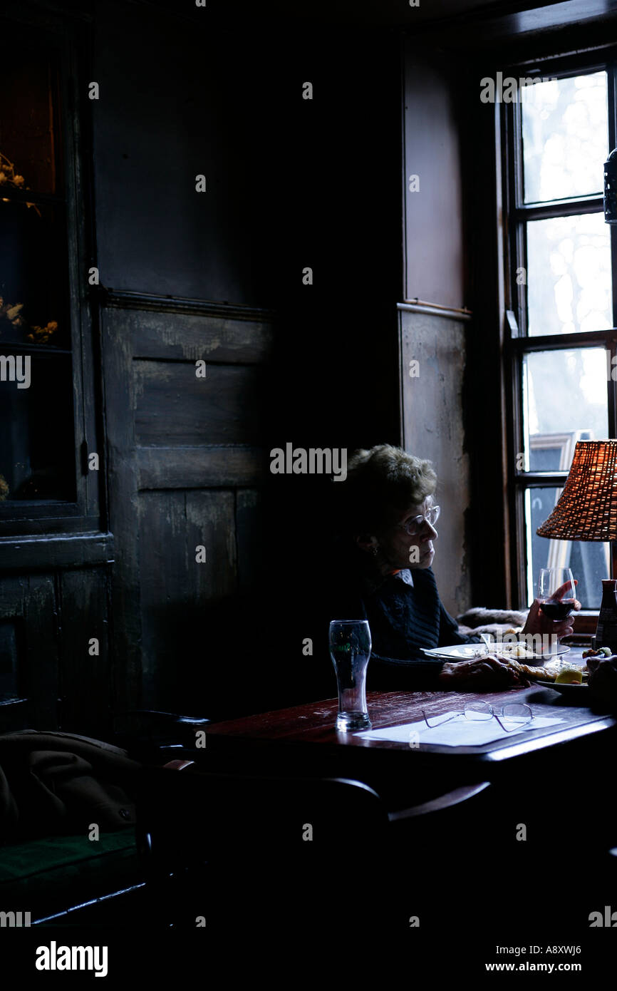 Old woman eating a pub lunch in The Spaniards Inn, North London Stock Photo