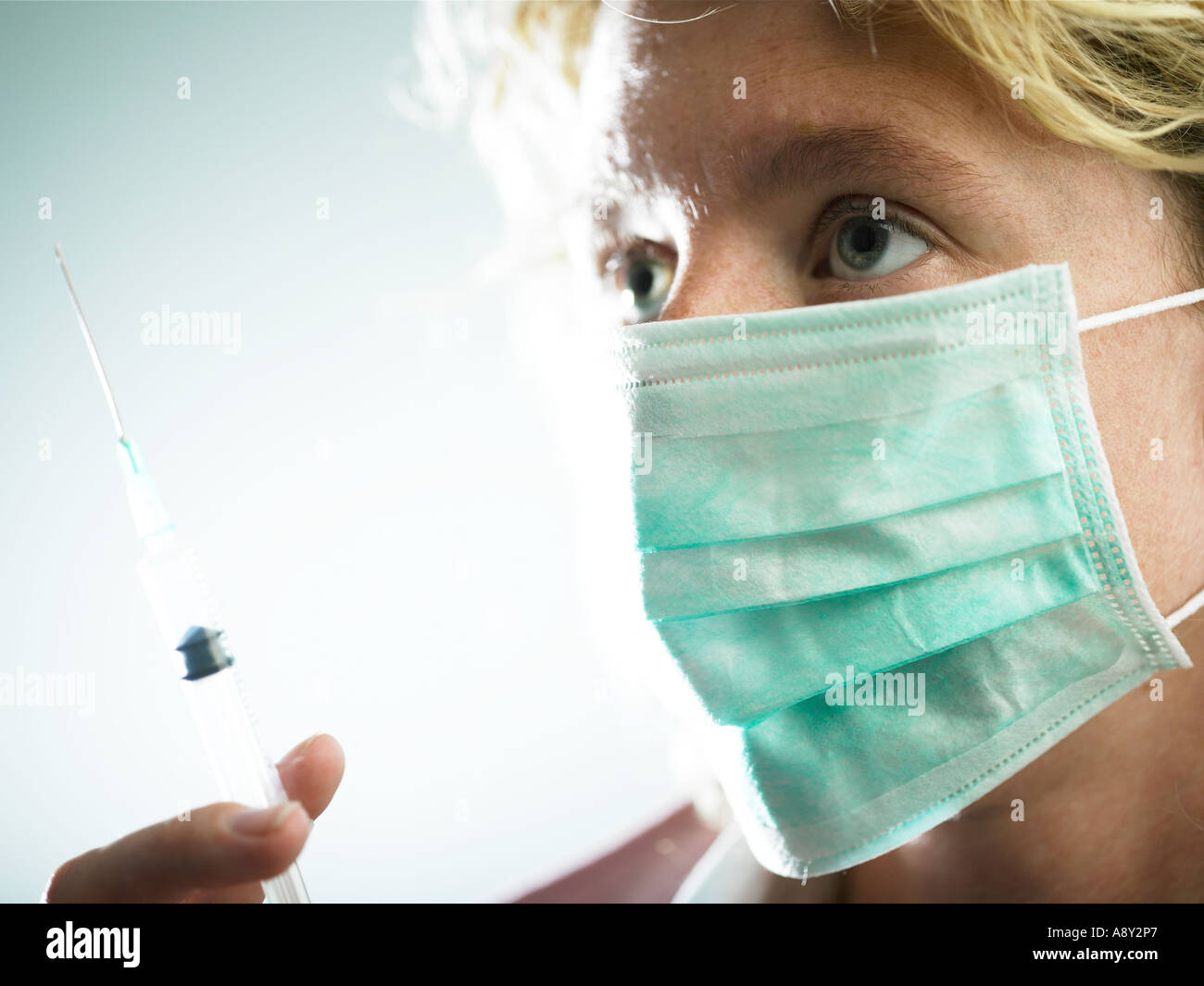 a health worker about to administer medication to patient via injection ...