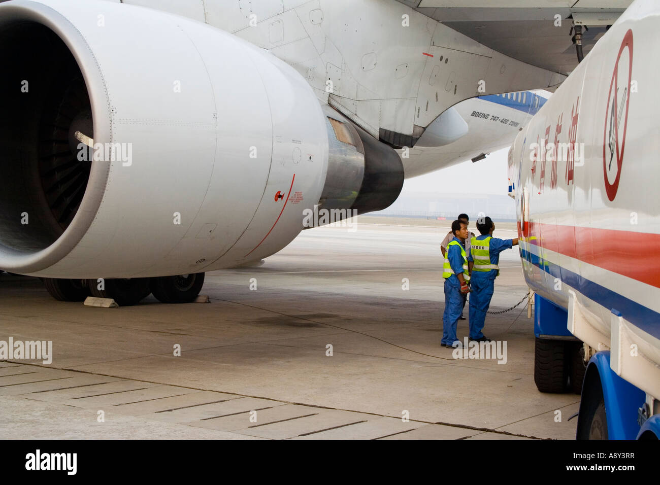 Ground Crew Refueling a China Air Airplane from a Fuel Truck Capital China International Airport Beijing China PEK BJS Stock Photo