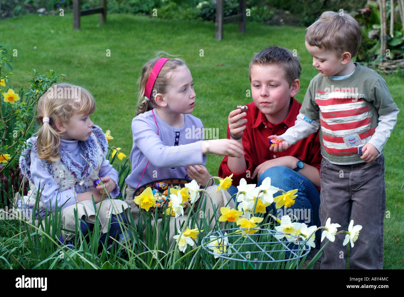 Easter egg hunting. A group of children sharing chocolate eggs Stock