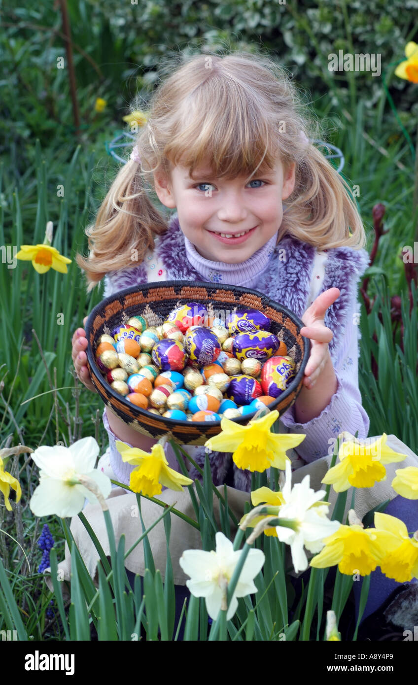 Easter egg hunting. A little girl with basket of chocolate eggs