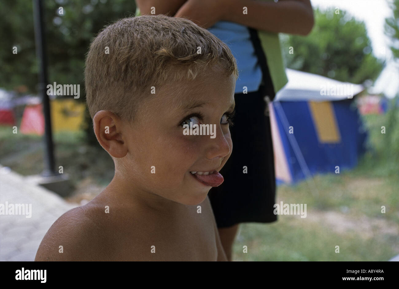 Mischievious kid (Iznik - Turkey). Gamin aux yeux bleus tirant la langue (Iznik - Turquie). Stock Photo