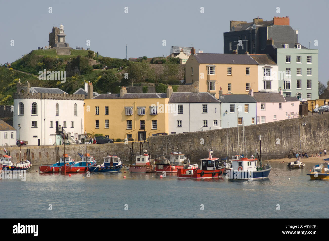 pastel coloured painted town houses by the harbour and beach