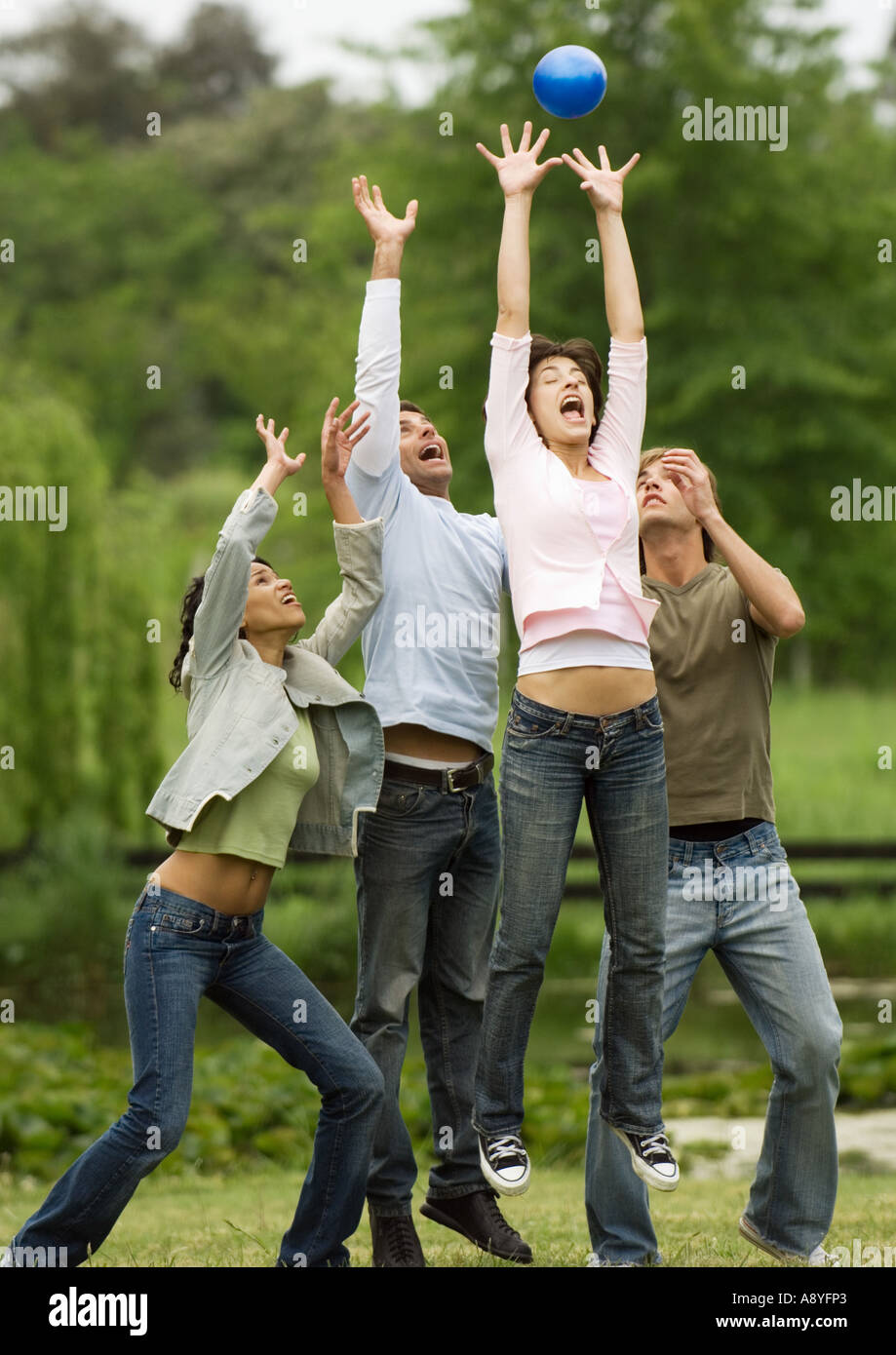 Young people jumping for ball Stock Photo Alamy