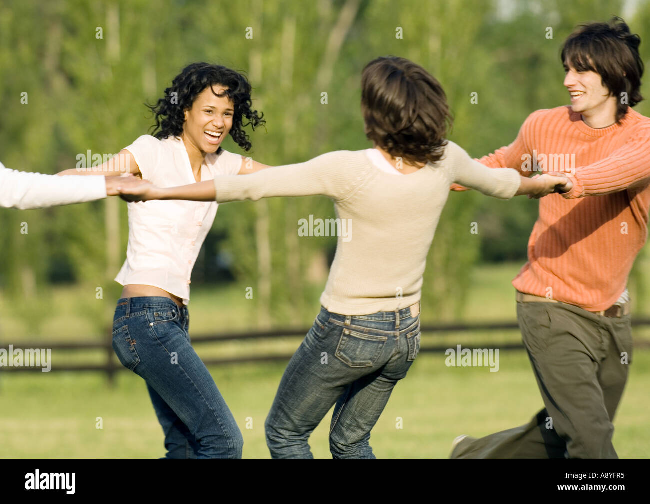 Young adult friends holding hands in circle Stock Photo - Alamy