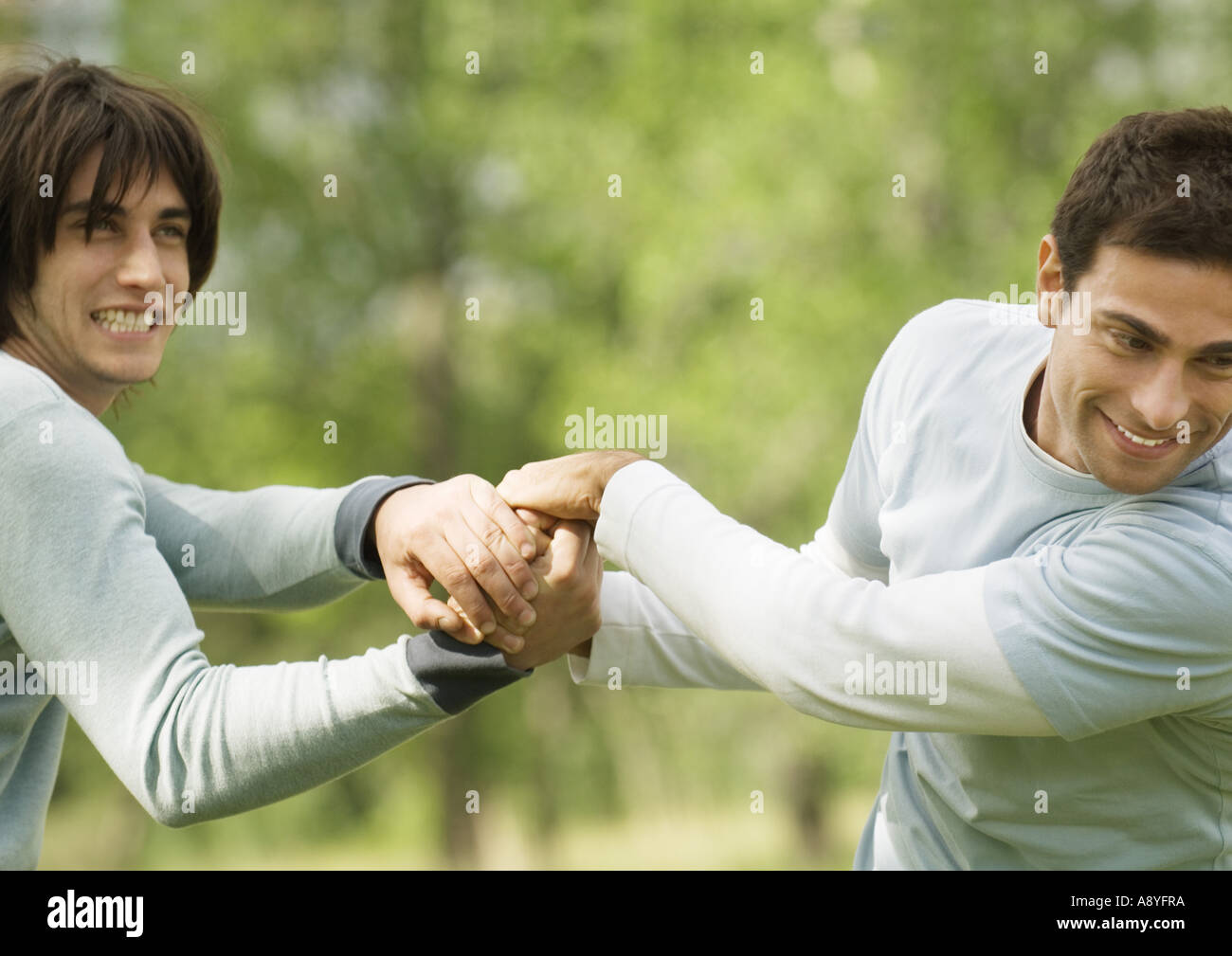 Two Male Friends Clasping Hands Playfully Stock Photo Alamy