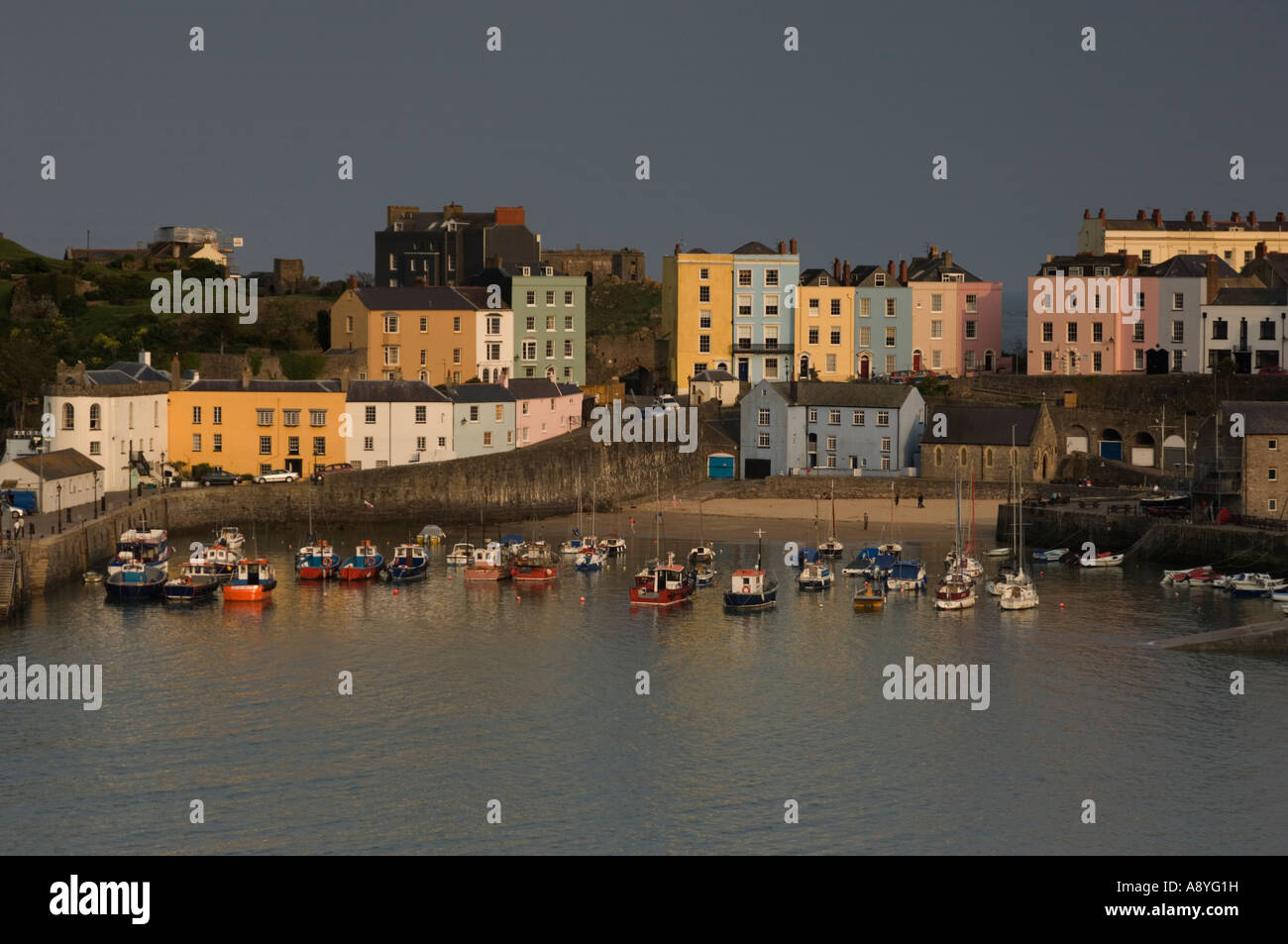 colourful houses at sunset Tenby harbour and north beach