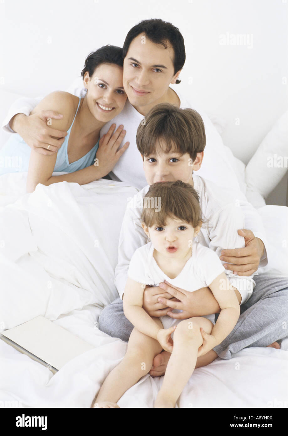Family in bed together Stock Photo