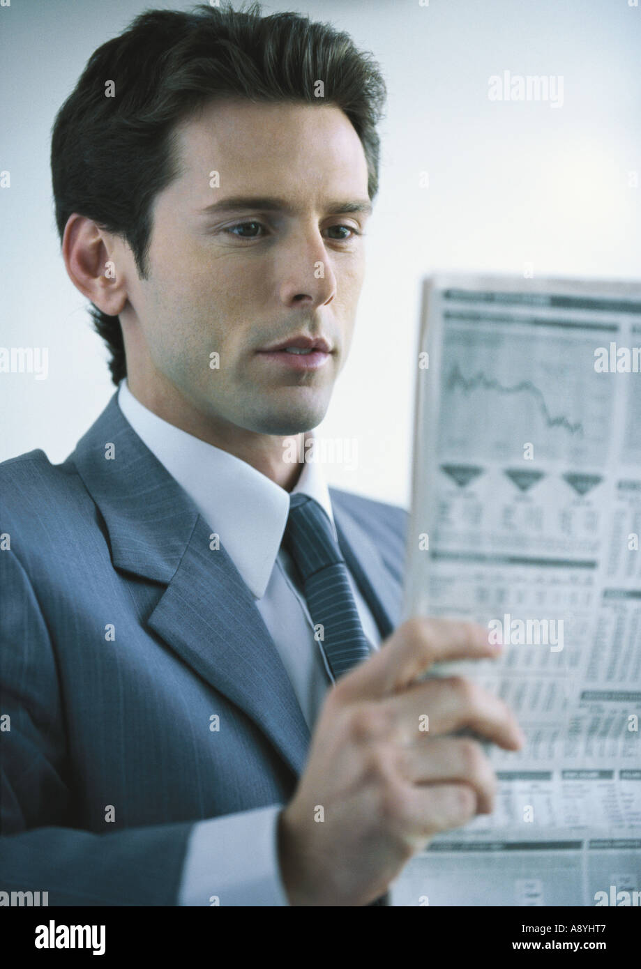 Businessman reading newspaper Stock Photo