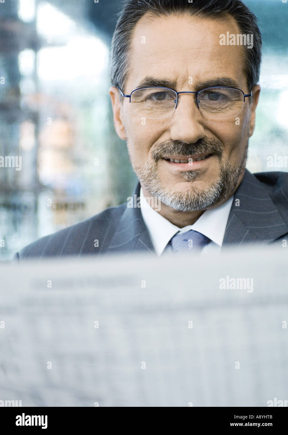 Businessman reading newspaper Stock Photo