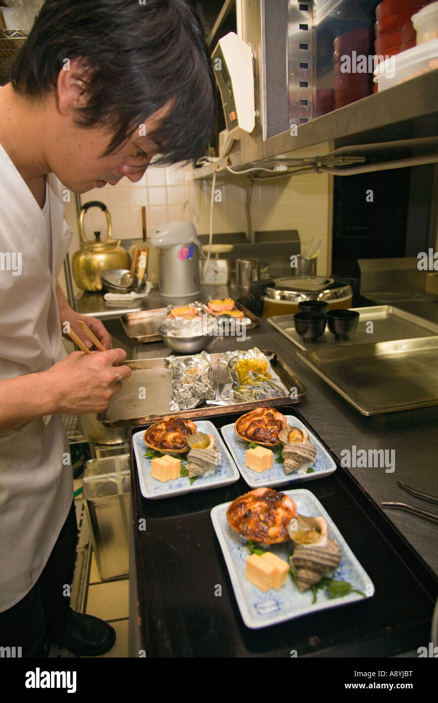 Preparing crab gratin with seashell and tofu in a Japanese restaurant Stock Photo